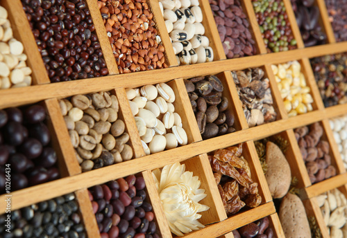 Indian spices, beans and seeds in a wooden frame