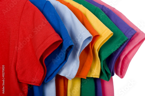 A row of colorful row t-shirts hanging on hangers