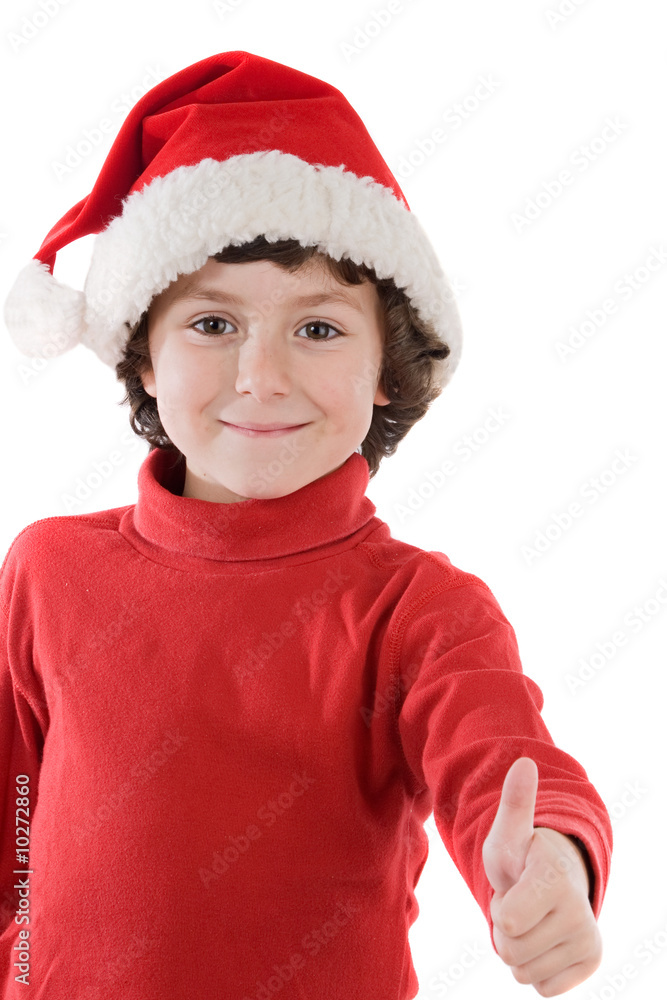 Adorable boy with red hat of Christmas saying O.K.