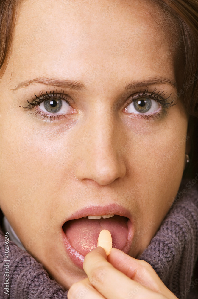 attractive young woman eating pill attractive young woman eating pill