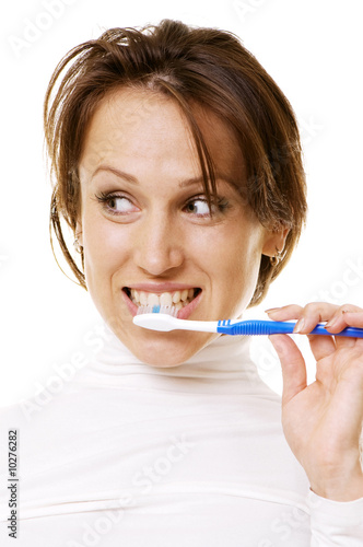 young woman cleaning her teeth. isolated on white