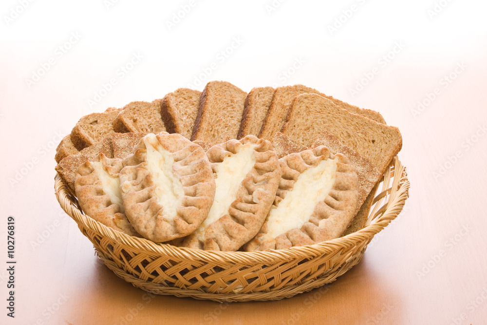 Bread in a plate from straw on a table