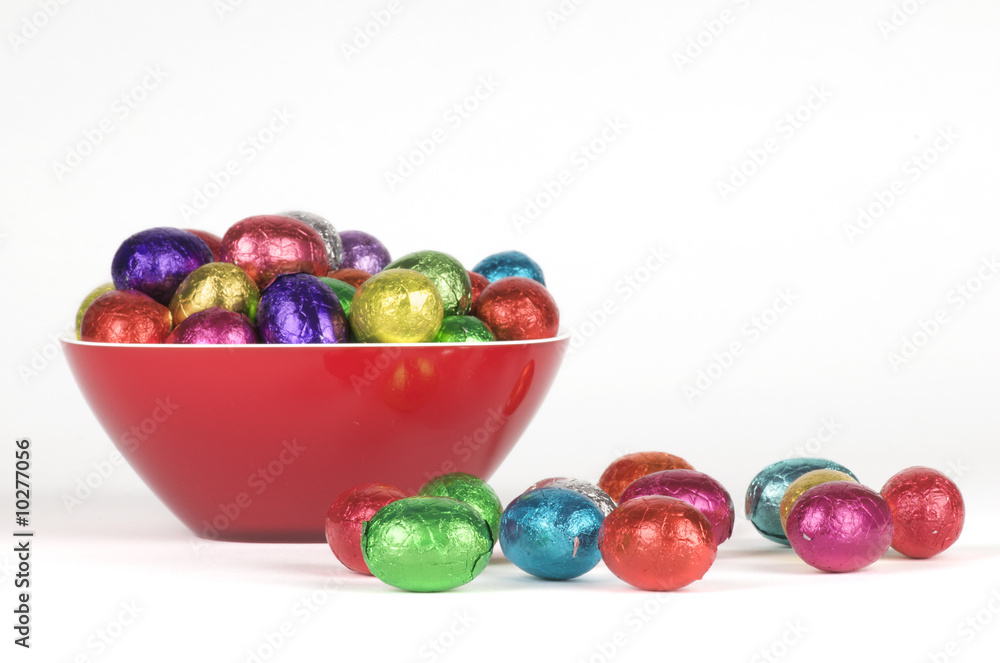 a dish filled with colorful easter chocolates a dish filled with colorful easter chocolates