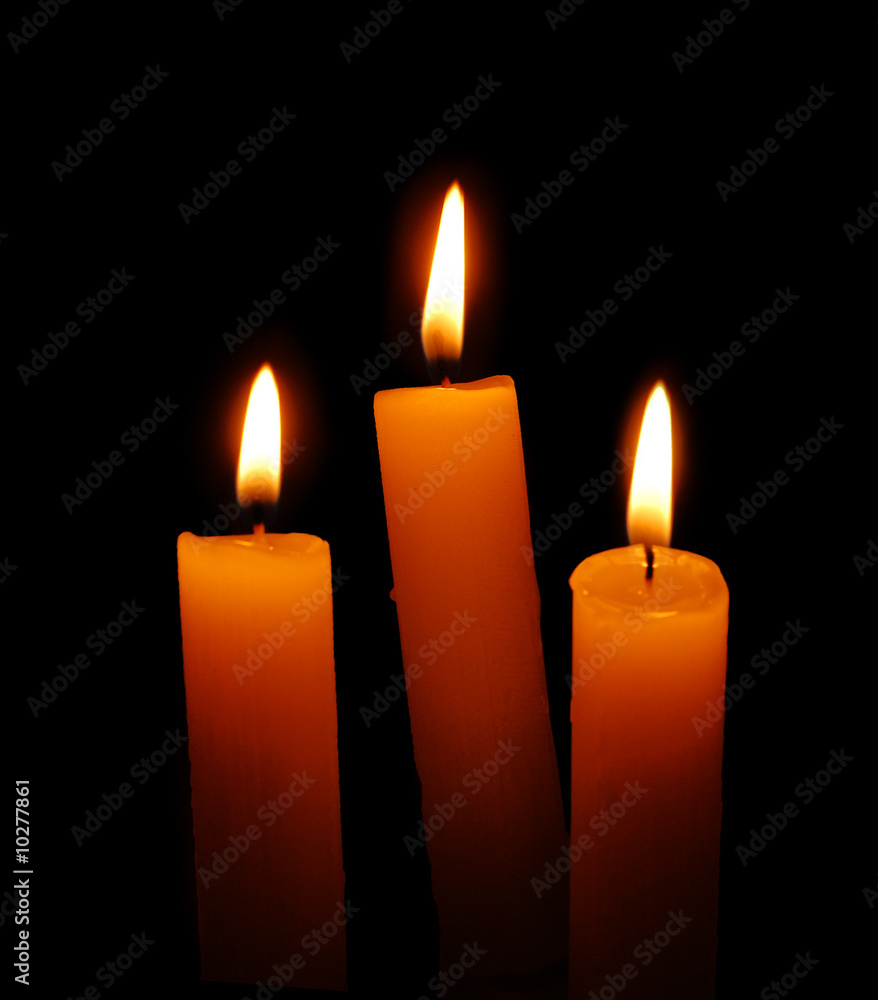 three candles over black background three candles over black background