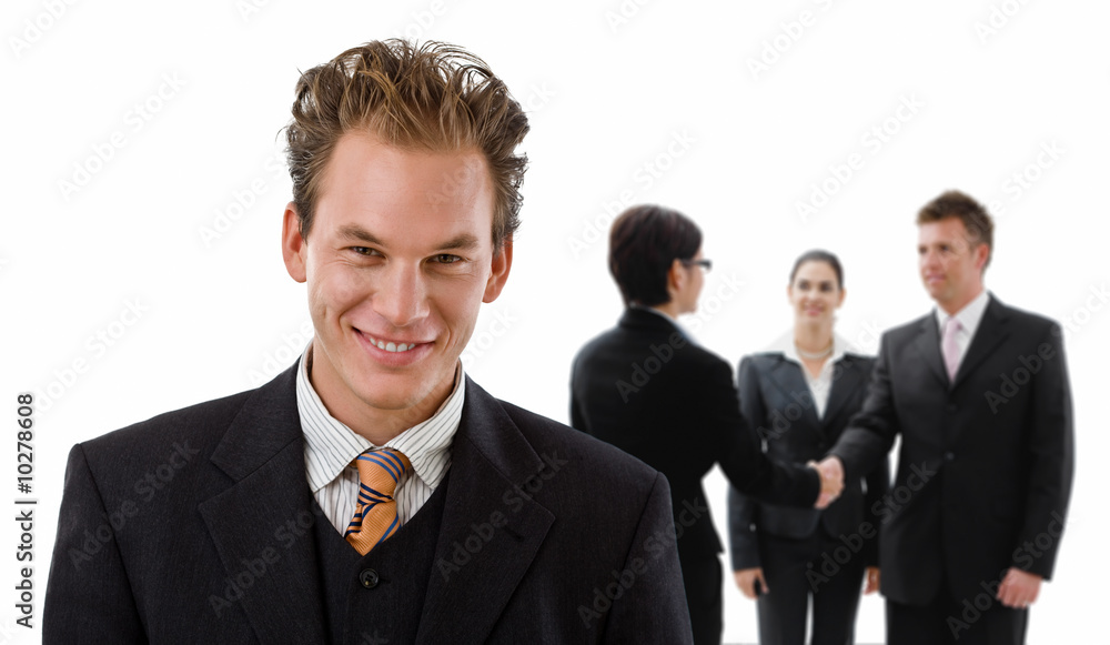 Team of business people, handsake in background. Team of business people, handsake in background.