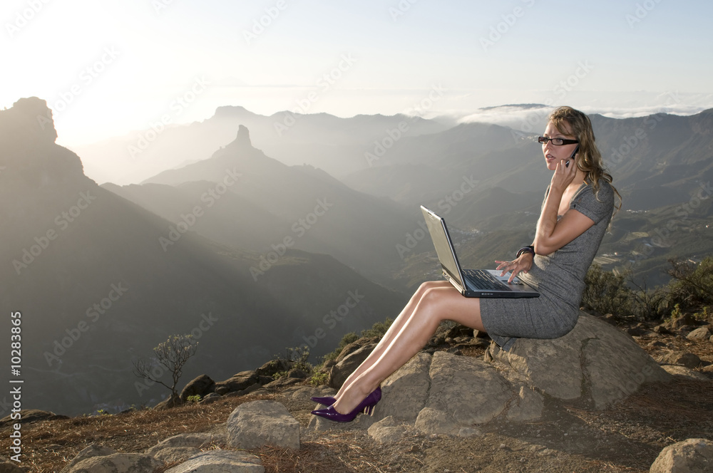 woman working with portatil laptop in the mountain