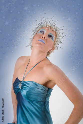 Mythical snow fairy or queen watching the winter snowflakes fall