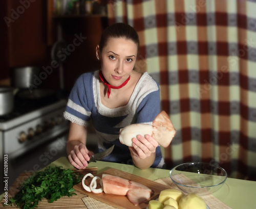 Slicing of boiled calamar on a cook-table photo