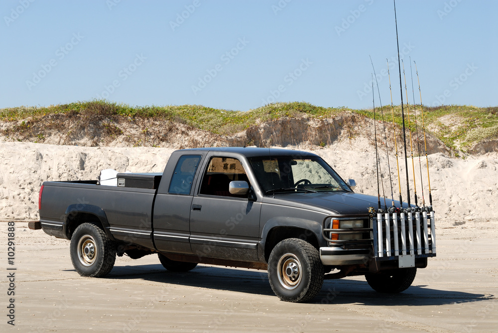 Fishermans pickup truck with anglind rods on the beach - obrazy, fototapety, plakaty 