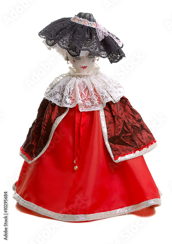 handmade doll in red dress and hat with lace on white background