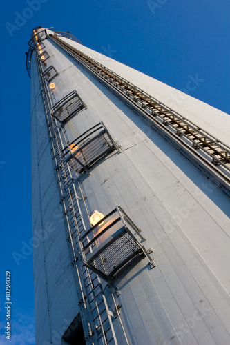 close view of a tall industrial chimney from the ground up