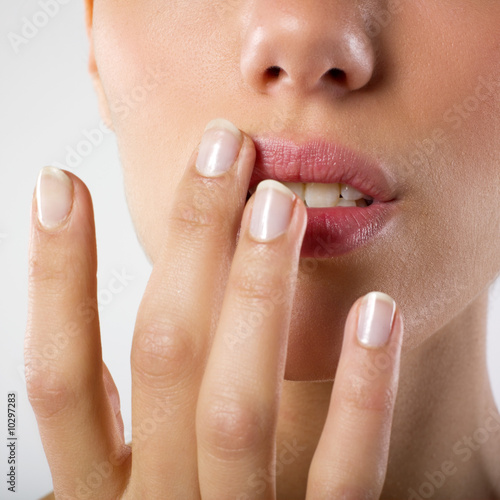 woman touching her lips with fingertips