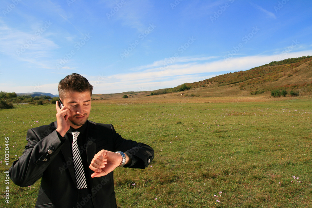 Checking watch while on the phone. Checking watch while on the phone.