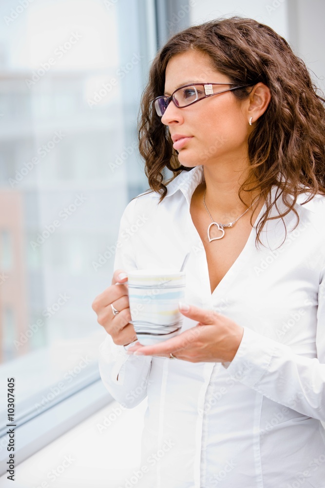 Young businesswoman standing in front of office window, Young businesswoman standing in front of office window,