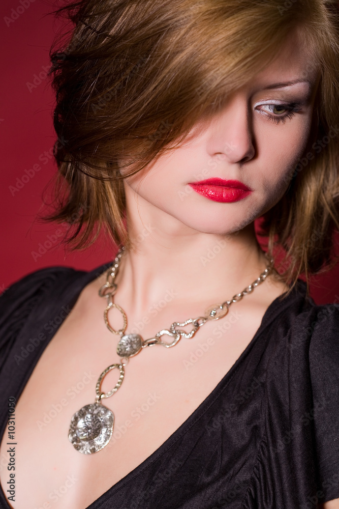Portrait of glamorous girl over red background