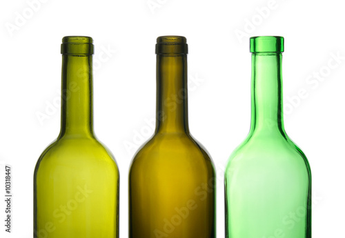 Three green empty wine bottles in a row.