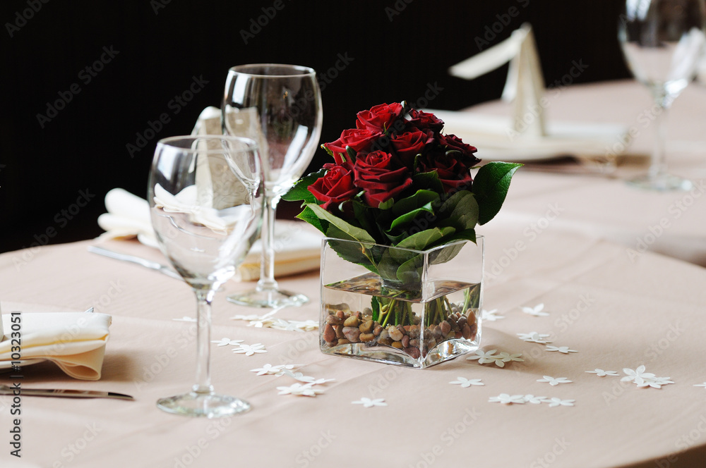 dark red rose arrangement on dinner table dark red rose arrangement on dinner table