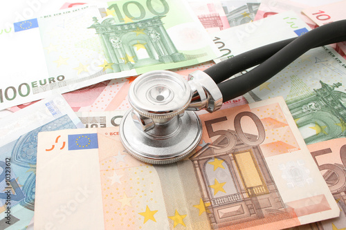money with stethoscope isolated on white