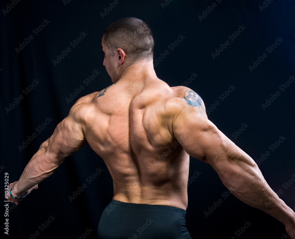 A perfect muscular man posing artistic, back double biceps A perfect muscular man posing artistic, back double biceps