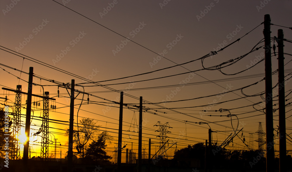 silhouettes of electrical wires on sunset