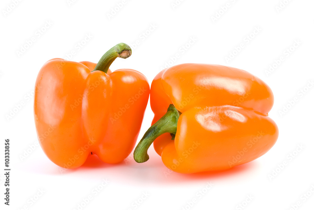 Pair of orange bell peppers isolated on the white background Pair of orange bell peppers isolated on the white background