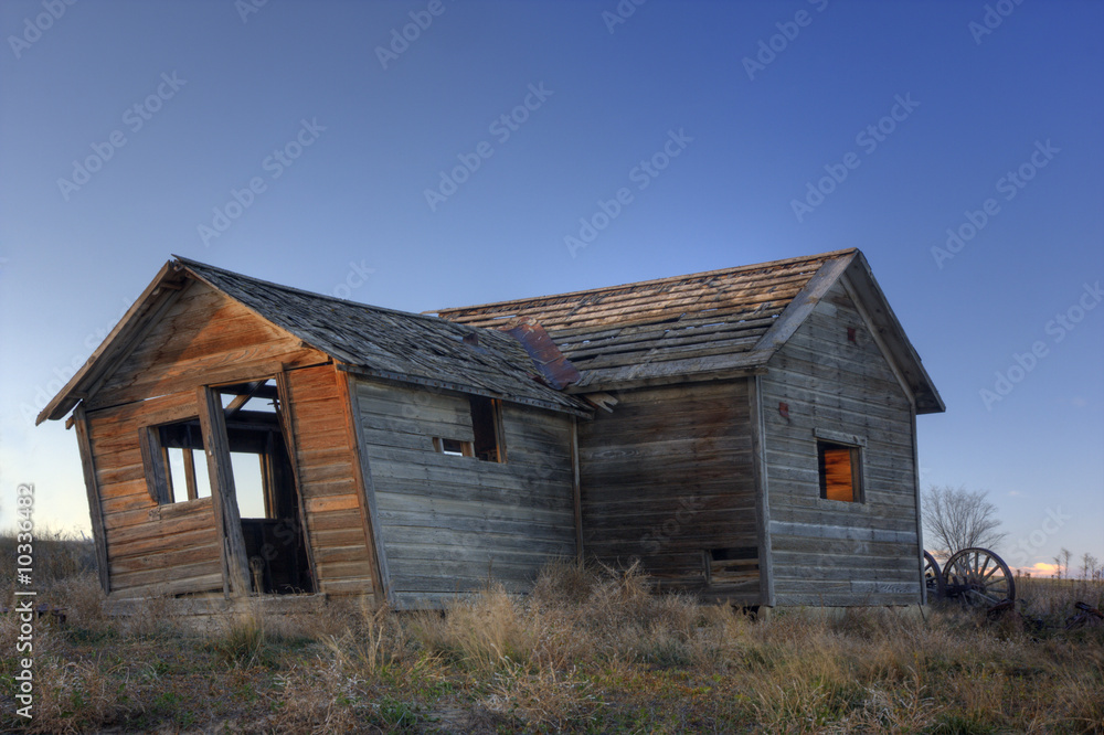 Old abandoned leaning farmhouse on Colorado prairie Old abandoned leaning farmhouse on Colorado prairie