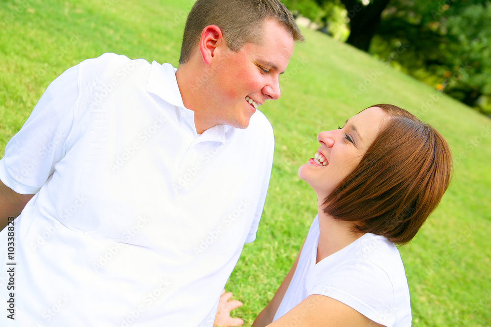 happy couple embracing in the park. young family happy couple embracing in the park. young family