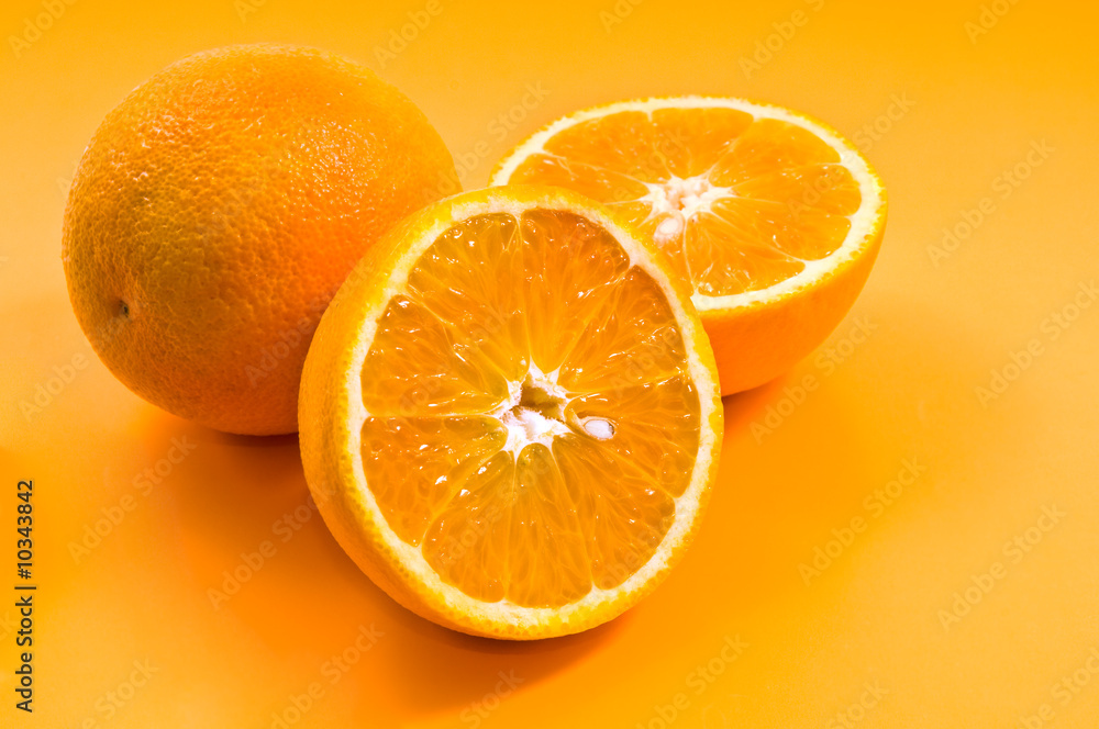 group of oranges on yellow background group of oranges on yellow background