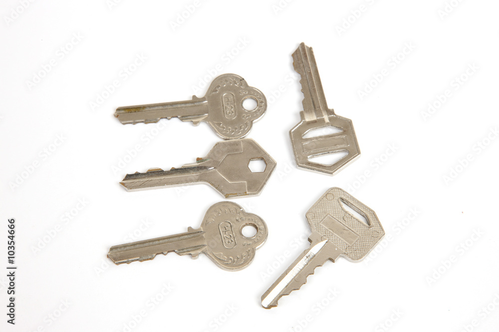 collection of metal keys on white background