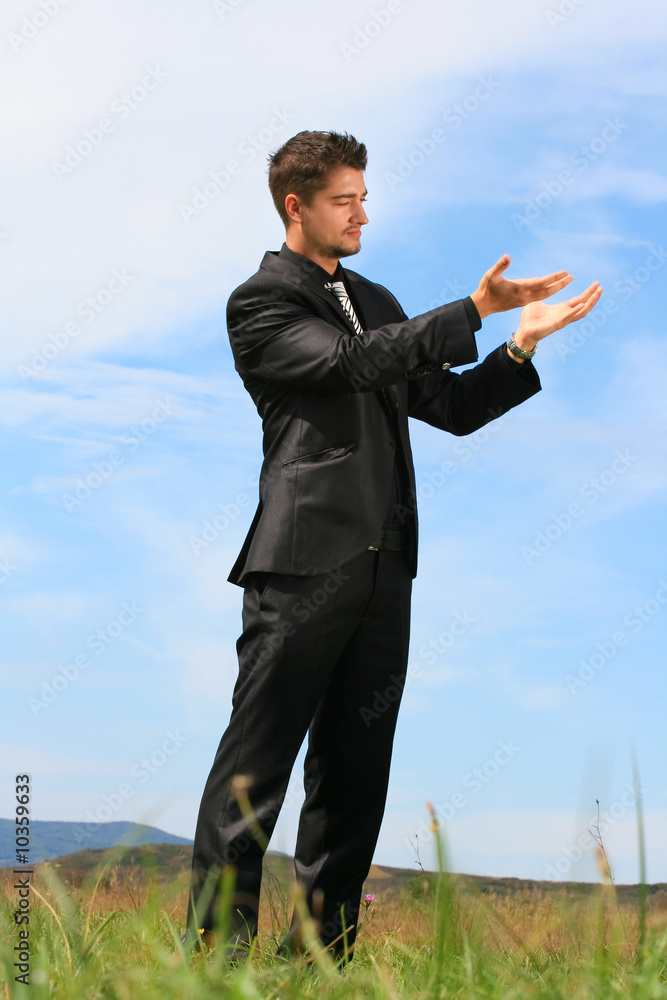 Holding an object in the palms of his hands. Holding an object in the palms of his hands.