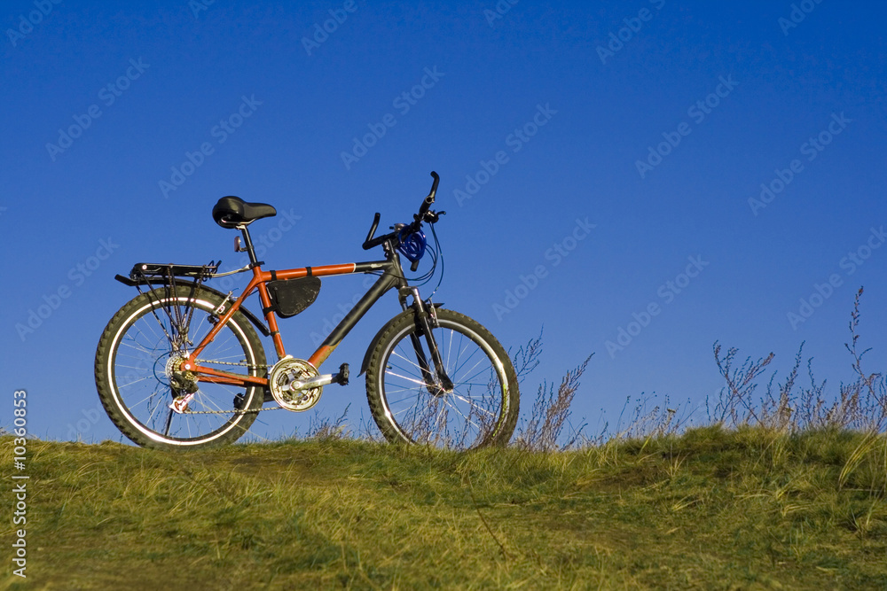 sports bicycle on an autumn meadow against the blue sky