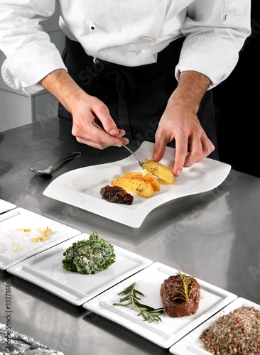 Chef preparing food on professional kitchen in restaurant