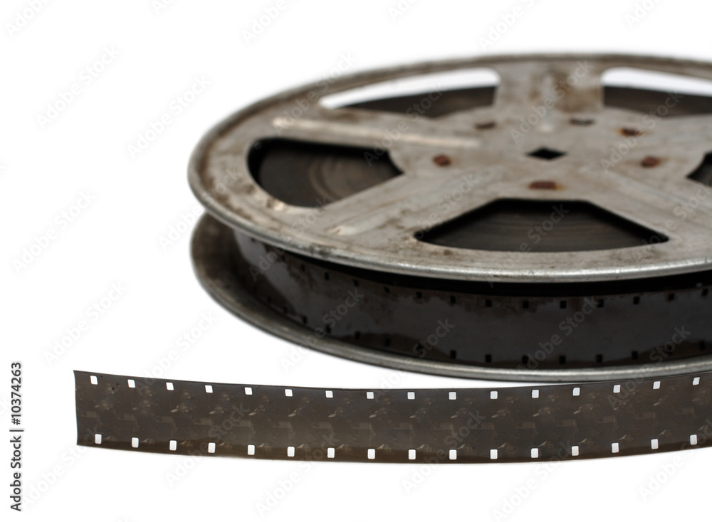 old movie film on metal reel close-up isolated on white