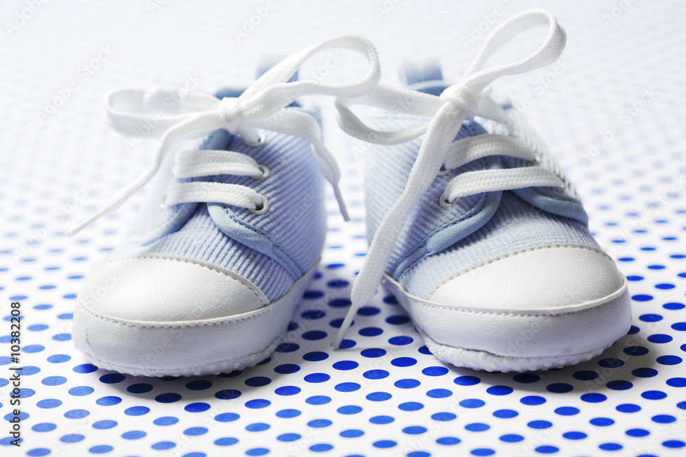 ltlle cute baby shoes on a blue pattern