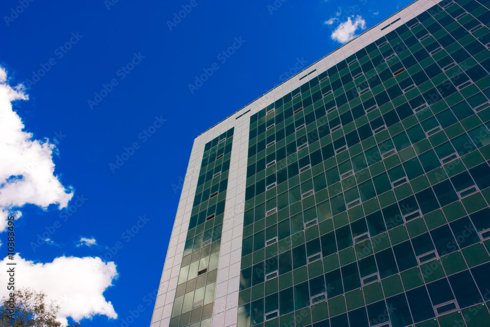 Fototapeta premium Skyscrapper and blue sky with clouds