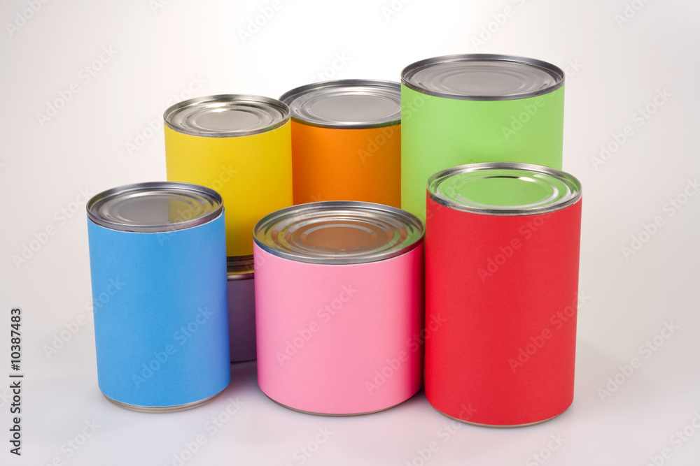 Close up shot of various tin cans with plain colored labels Close up shot of various tin cans with plain colored labels