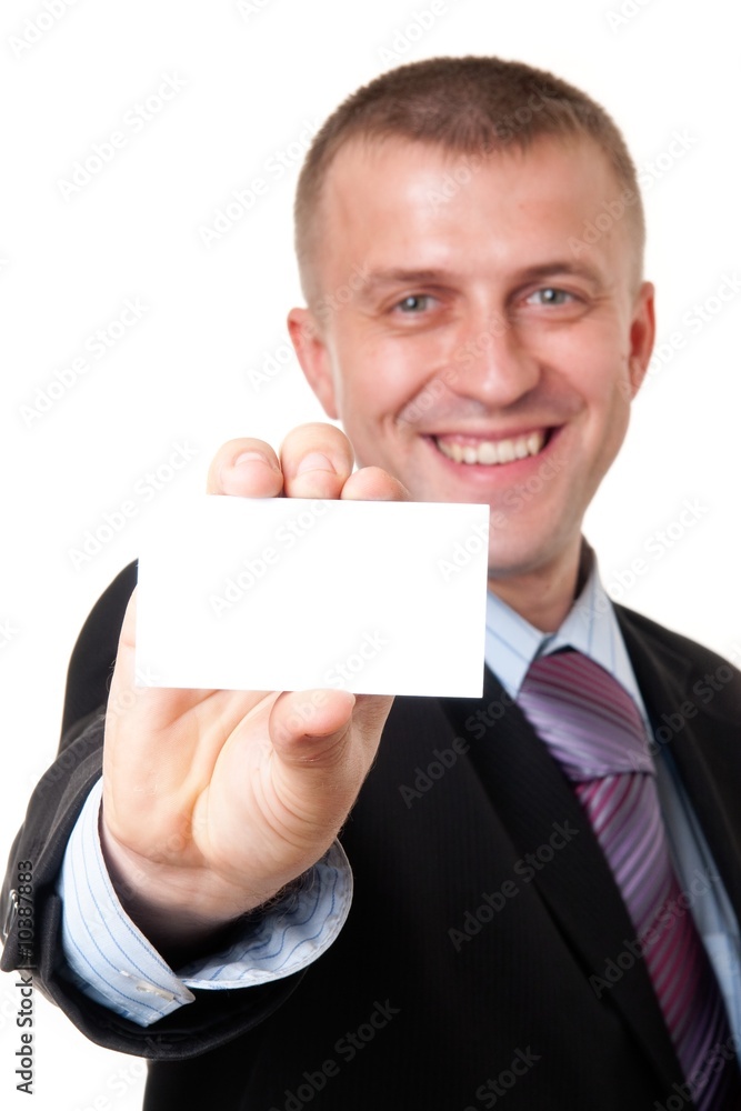 smiling young businessman holding a blank business card smiling young businessman holding a blank business card