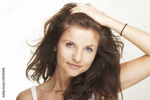 A happy young woman with facial expression on white background