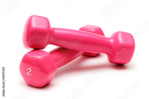 two pink dumbbells on the white background