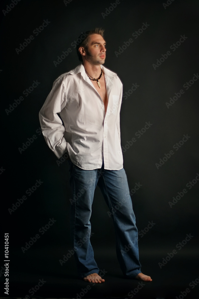 young man in a white shirt on a black background young man in a white shirt on a black background