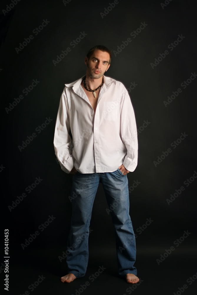young man in a white shirt on a black background