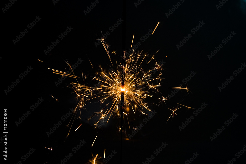 one christmas sparkler against the black background one christmas sparkler against the black background