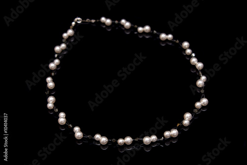 A pearl beads necklace isolated on black background.