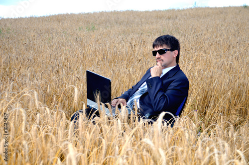 Thoughtful young businessman in field