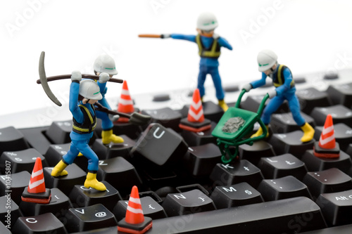 computer repair concept - workers repairing keyboard