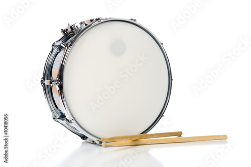A new silver snare drum with sticks on a white background photo