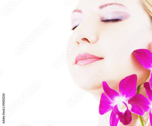 Face of young woman with closed eyes on white background