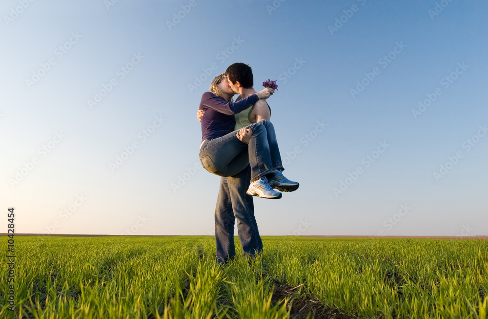 The guy holds the girl on hands and kisses The guy holds the girl on hands and kisses