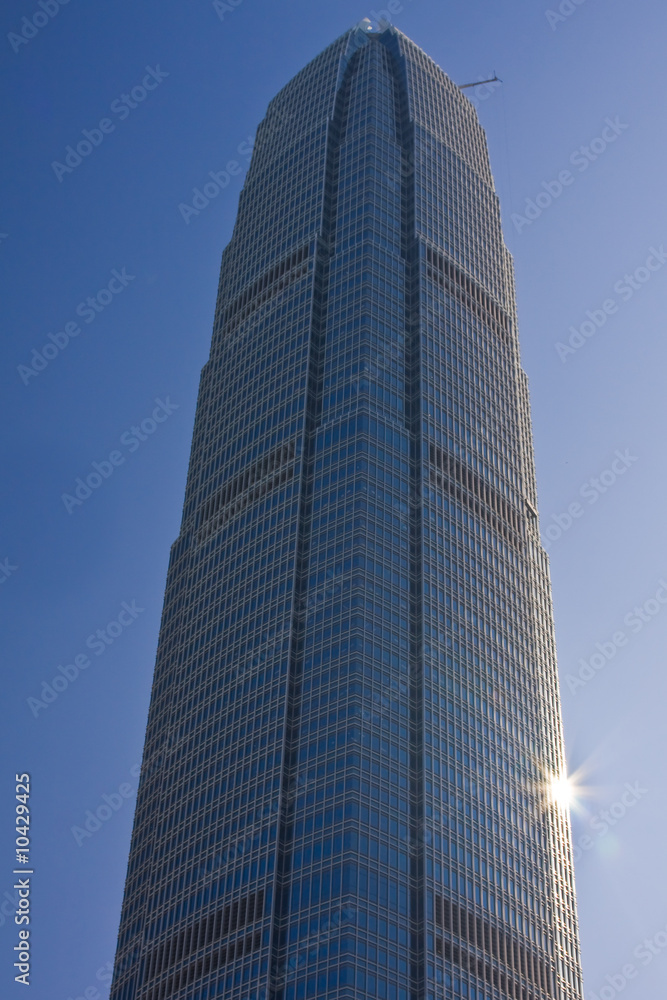 Large office building with sun reflecting off it