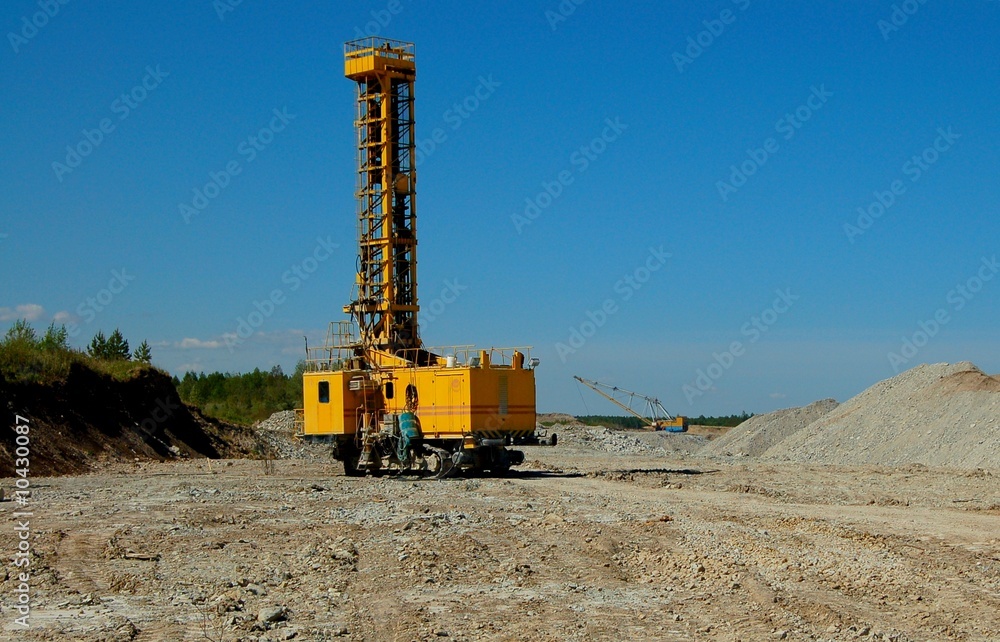 Drillihg machine in open cast mining quarry